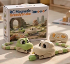 RC Magnetic Greedy Snake toy set with a green and cream plastic snake, a matching remote control, and the product packaging box on a light wooden surface.